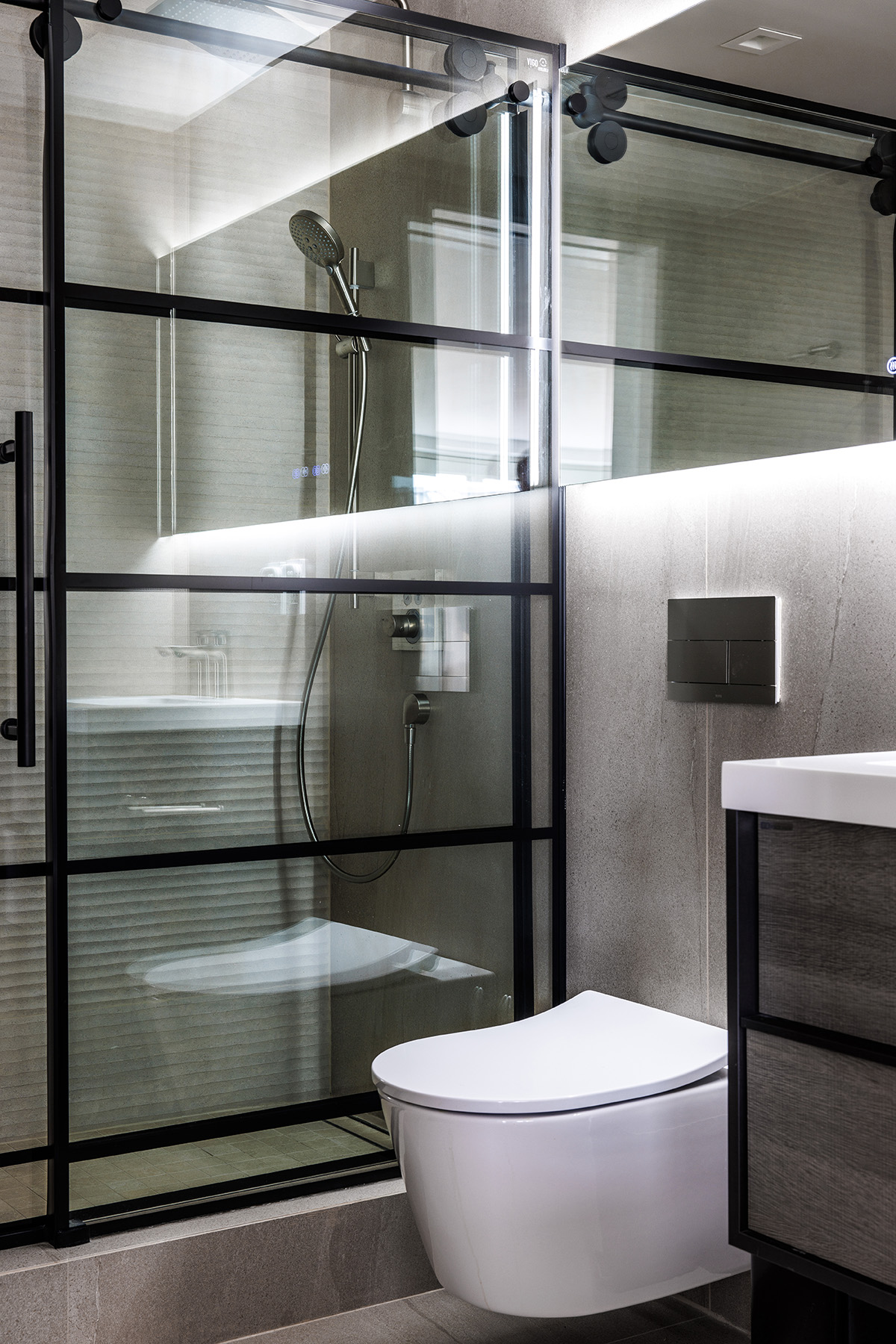 Modern Bathroom with Gray Tiles, White Fixtures, Black Metal and Glass Doors 